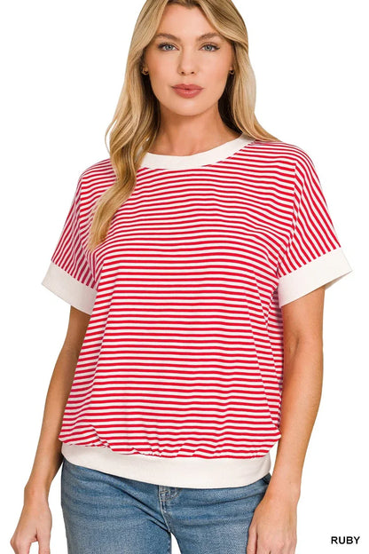 Woman wearing a red and white striped short sleeve top with relaxed fit and white trim.