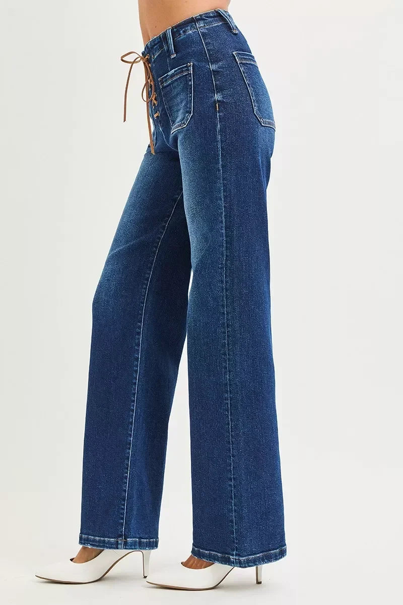 Women's high-waisted wide-leg jeans with front lace-up detail and white heels