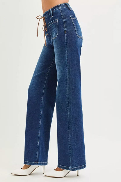 Women's high-waisted wide-leg jeans with front lace-up detail and white heels