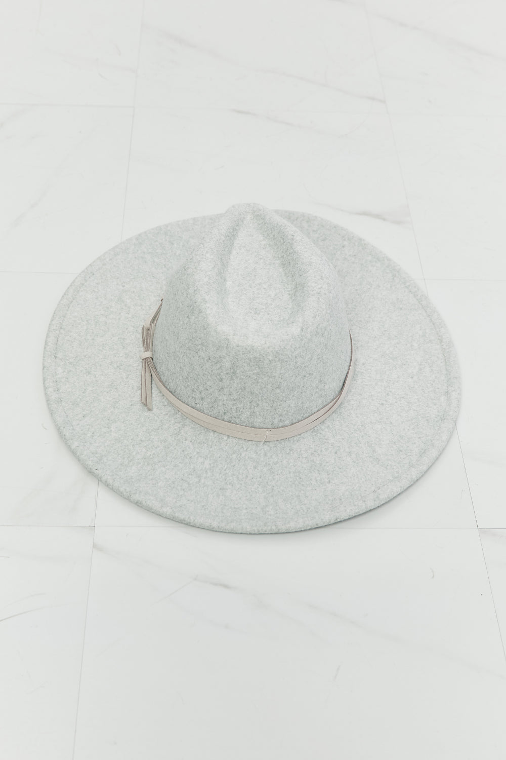 a wide brim Gray felt fedora hat with a leather tie detail on a white background
