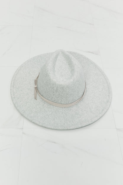 a wide brim Gray felt fedora hat with a leather tie detail on a white background