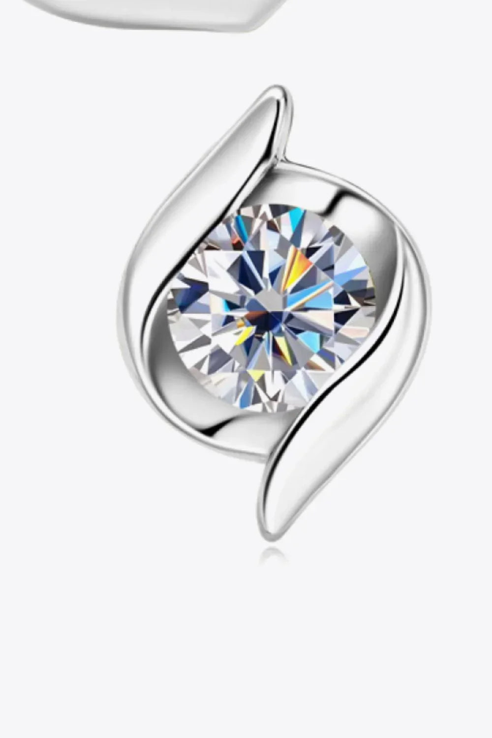 Close-up of a modern silver pendant with a round brilliant-cut gemstone center