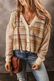 Woman wearing a patterned knit cardigan with large buttons, blue jeans, and a brown crossbody bag.