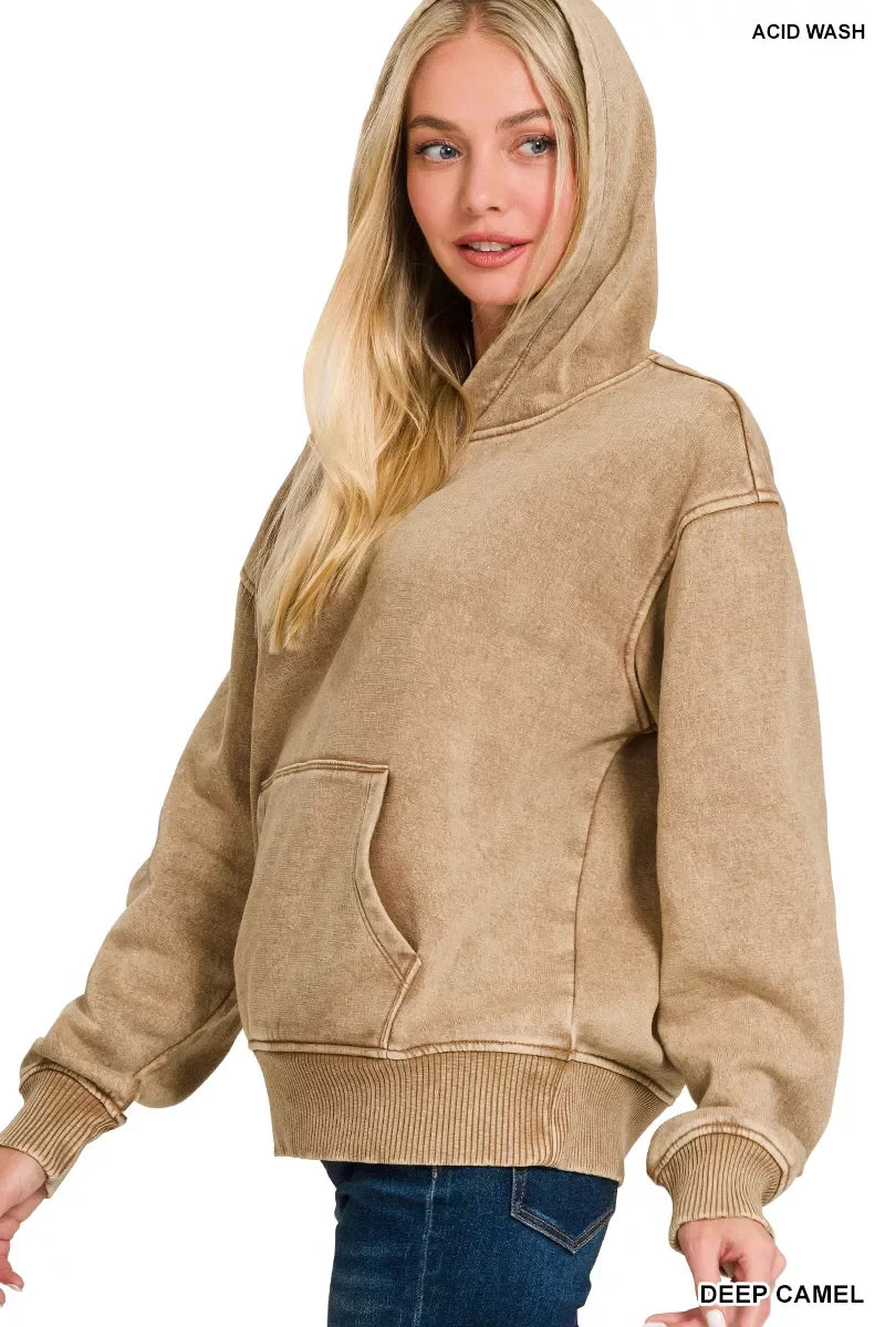 Woman wearing an acid wash deep camel hoodie with kangaroo pocket and relaxed fit.