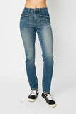 Woman wearing high-rise straight leg blue jeans with front patch pockets and sneakers