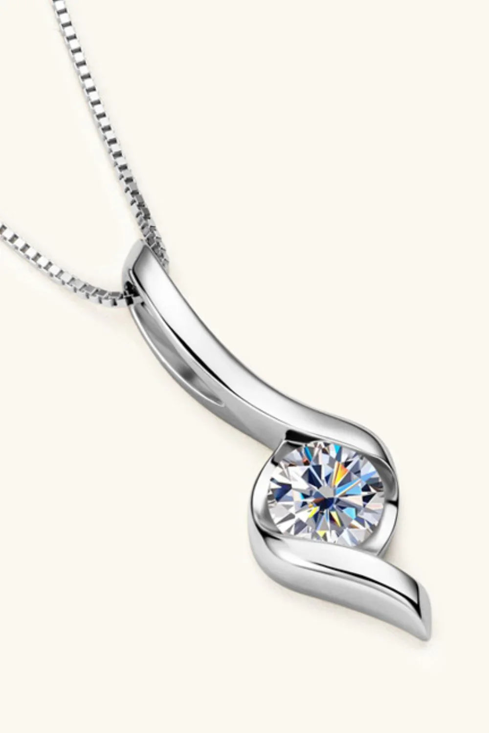 Modern silver pendant necklace with round clear gemstone in elegant curved setting
