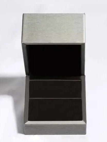 Empty silver jewelry box with open lid on a white background