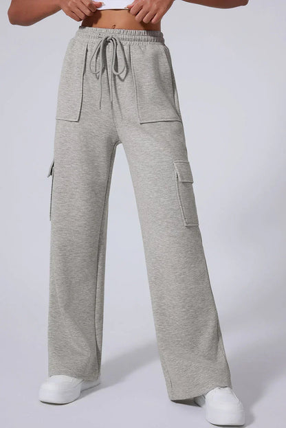 Women's light grey wide-leg cargo sweatpants with drawstring waist and patch pockets