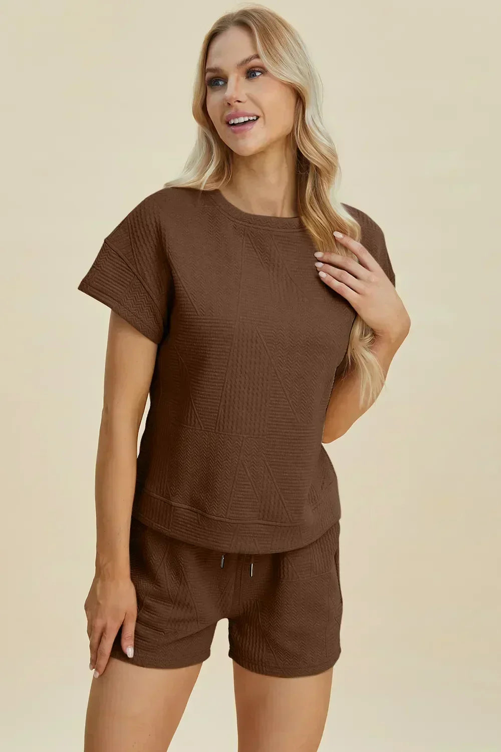 Woman wearing brown textured short sleeve lounge set with relaxed fit shorts