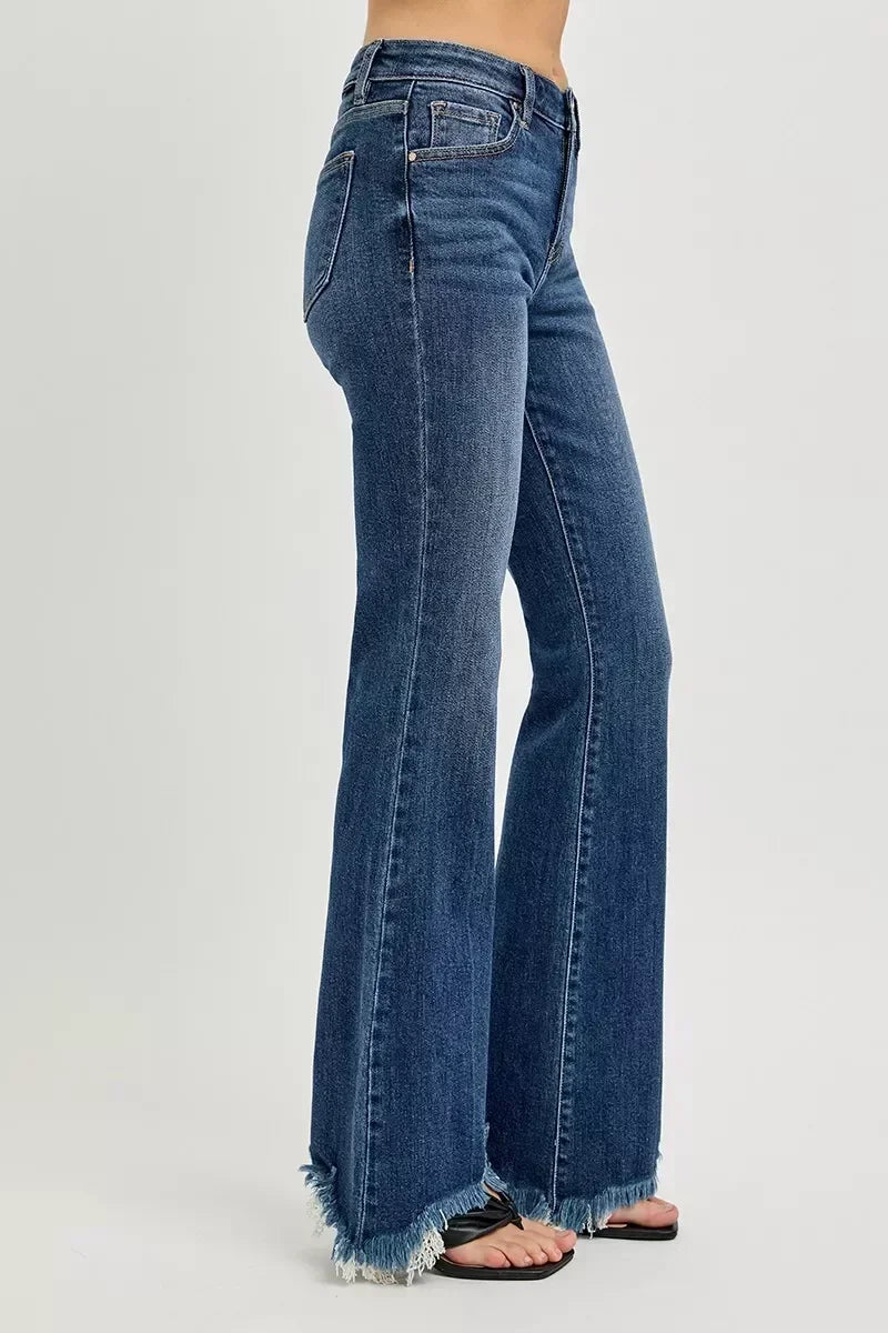 Women's high-waisted flared jeans with frayed hems in dark blue denim.