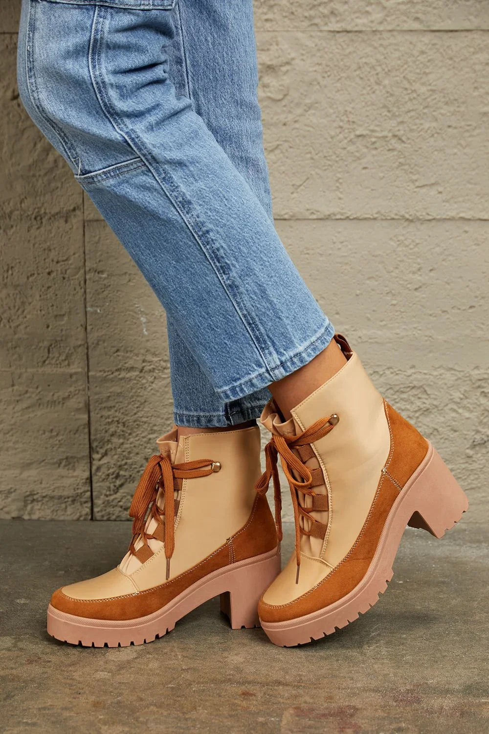 Tan suede and leather lace-up ankle boots with block heel, styled with blue jeans