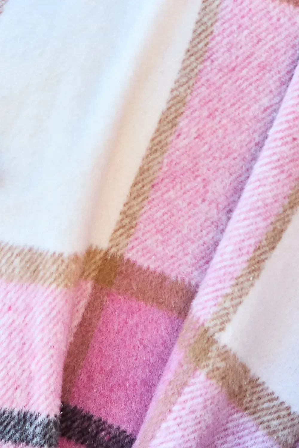 Soft pink and cream plaid wool fabric with beige stripes, close-up texture