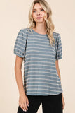 Woman wearing a short sleeve blue and white striped blouse with puff sleeves