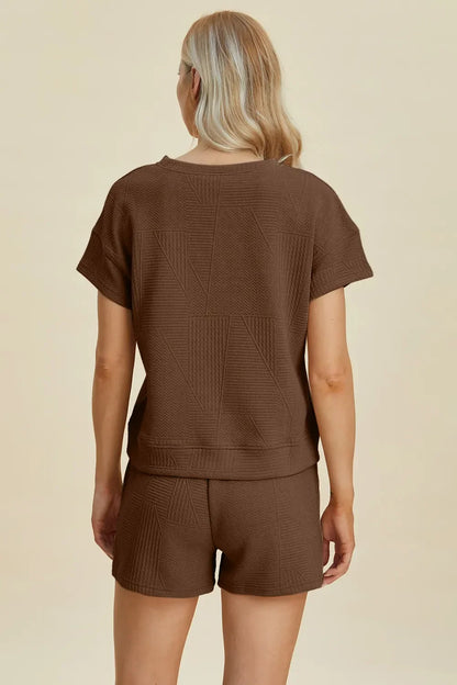 Woman wearing brown textured short-sleeve top and matching shorts, viewed from back