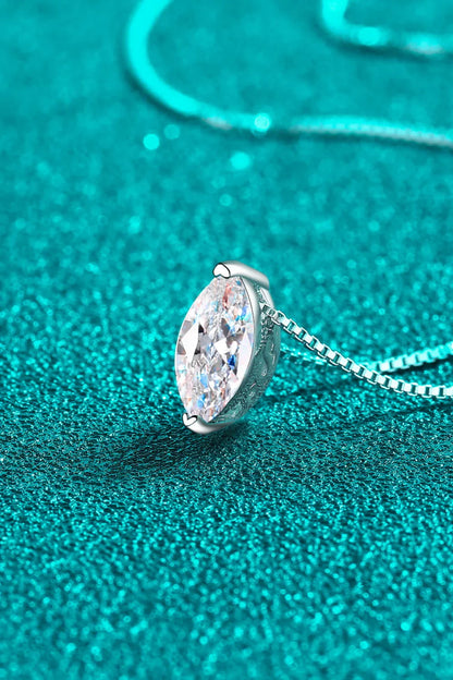Marquise-cut gemstone pendant necklace in silver on a sparkling teal background