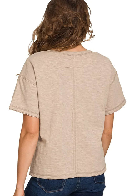 Back view of a woman in a relaxed-fit ash mocha short sleeve t-shirt and blue jeans