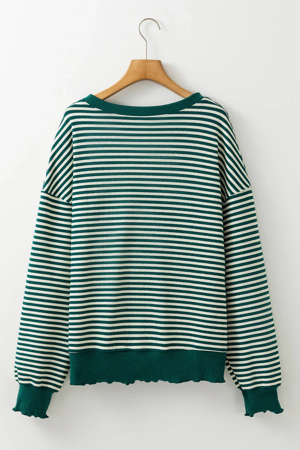 Green and white striped long sleeve pullover sweater with ribbed cuffs and hem on hanger