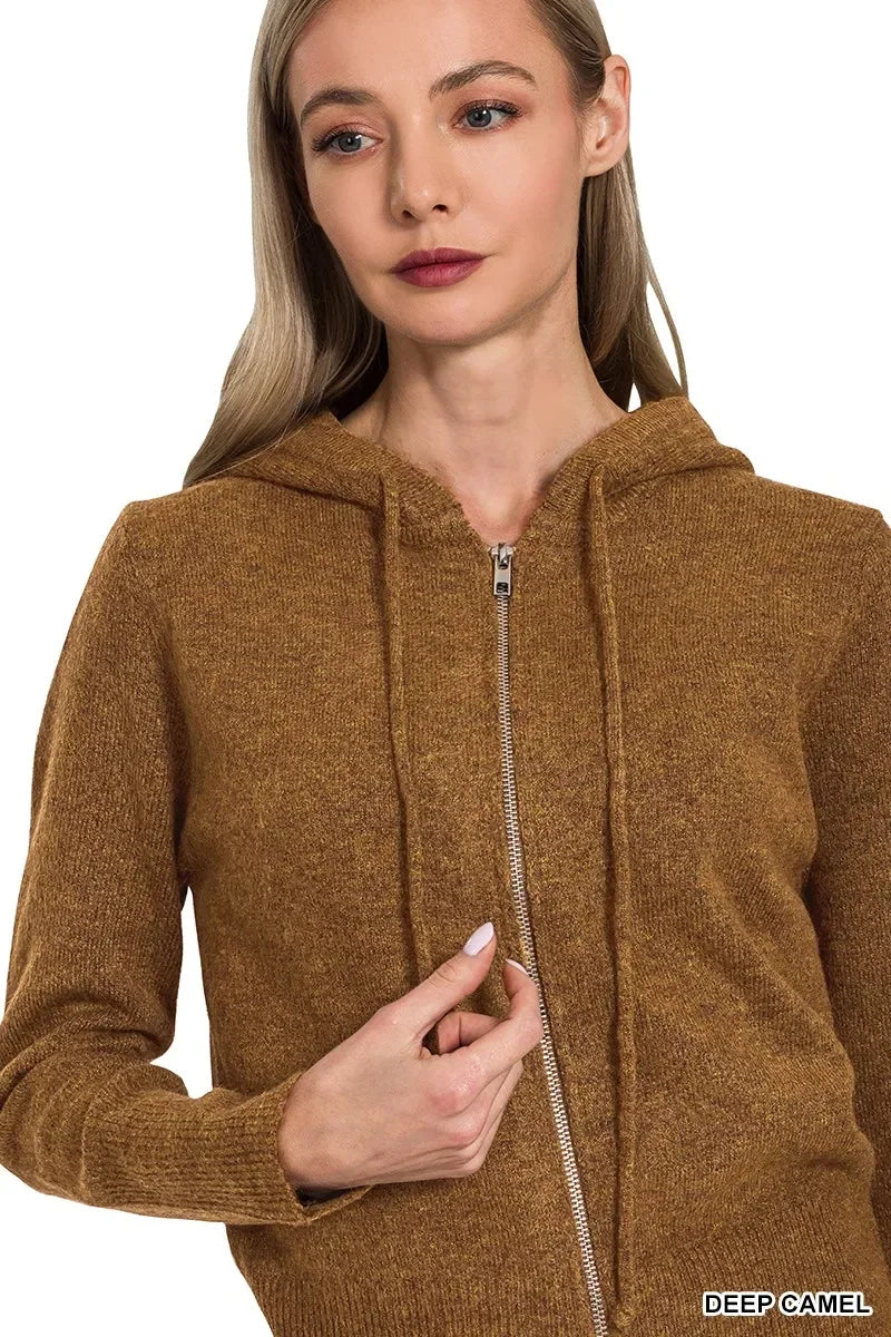 Woman wearing a deep camel zip-up knit hoodie with long sleeves and relaxed fit.