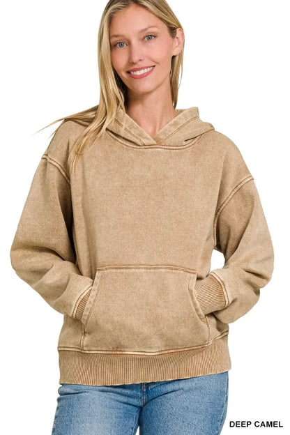 Woman wearing a deep camel hooded sweatshirt with kangaroo pocket and relaxed fit