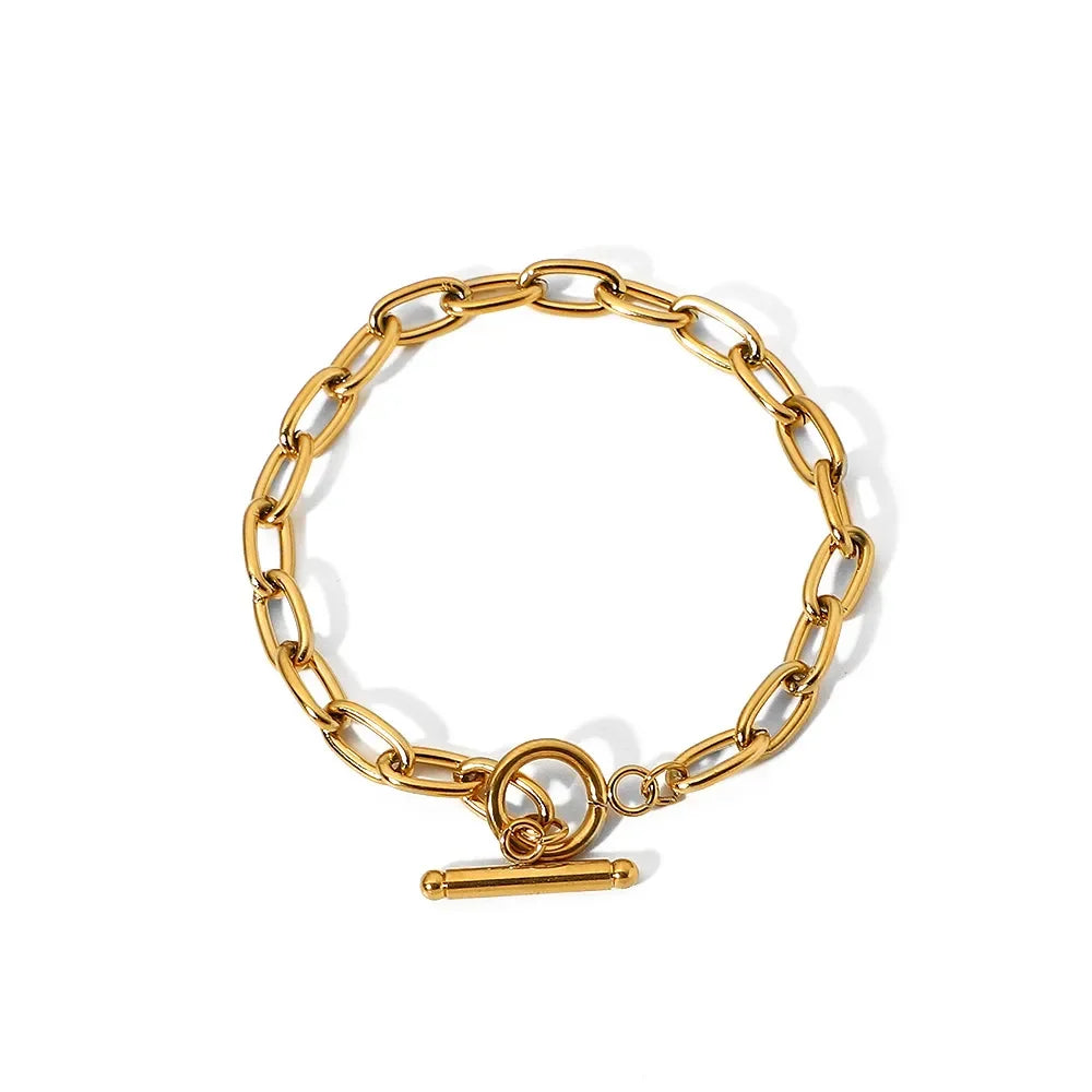 Gold chain link bracelet with a toggle clasp on a white background