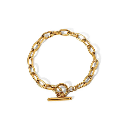 Gold chain link bracelet with a toggle clasp on a white background