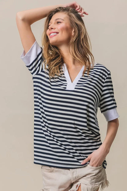 Woman wearing a BiBi Contrast Striped Notched Knit Top with rolled sleeves and beige distressed shorts