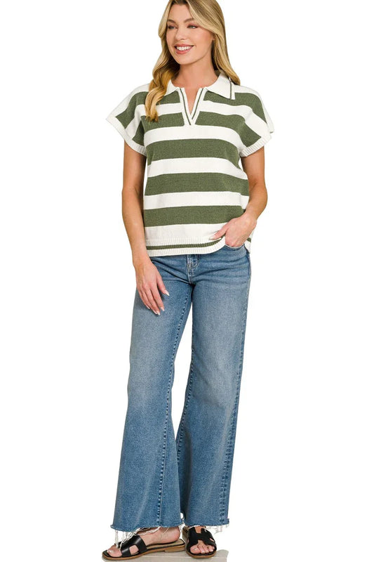 Woman wearing green and white striped short-sleeve knit top with wide-leg blue jeans.