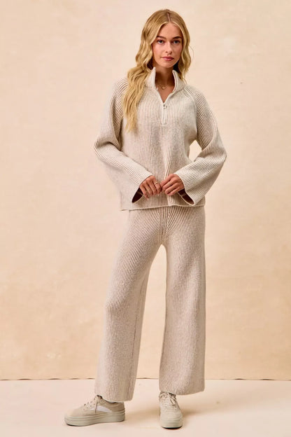 Woman wearing a beige ribbed knit lounge set with wide-leg pants and collared sweater