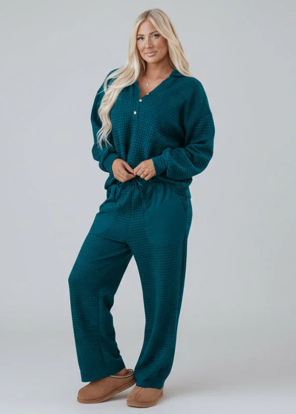 Woman in teal textured lounge set with relaxed fit, standing against neutral background