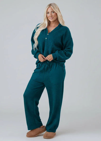 Woman in teal textured lounge set with relaxed fit, standing against neutral background