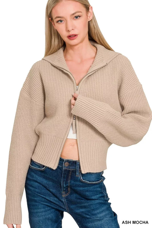 Woman wearing a ribbed ash mocha zip-up knit sweater with blue jeans.