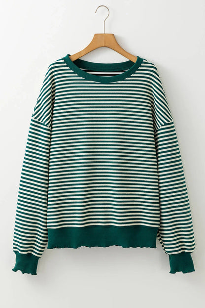 Green and white striped long sleeve sweater with ribbed cuffs and relaxed fit, on hanger