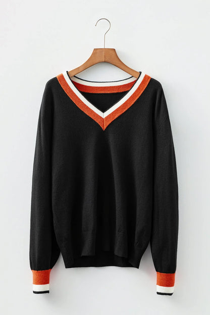 Black V-neck sweater with orange and white trim on collar and cuffs, hanging on wooden hanger