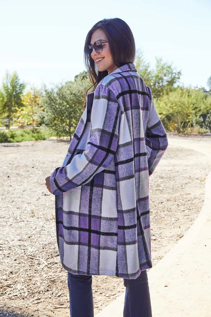 Woman outdoors wearing a purple plaid long coat with relaxed fit and sunglasses