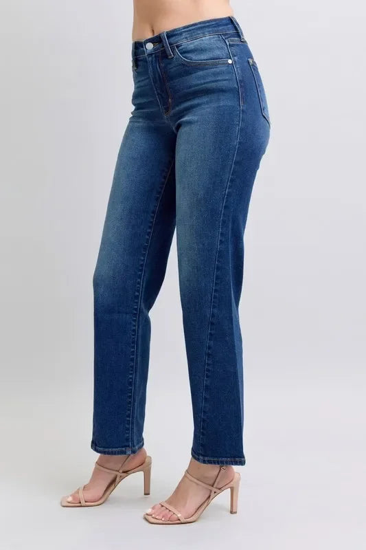 Woman wearing high-waisted straight leg blue jeans and nude heeled sandals