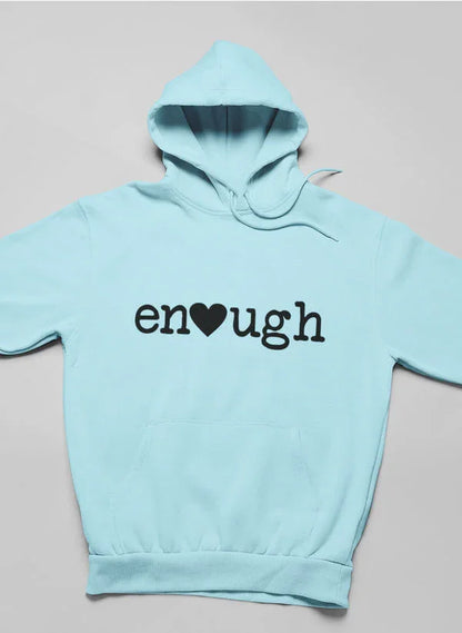 Light blue women's hoodie with 'enough' and heart graphic on front, laid flat.