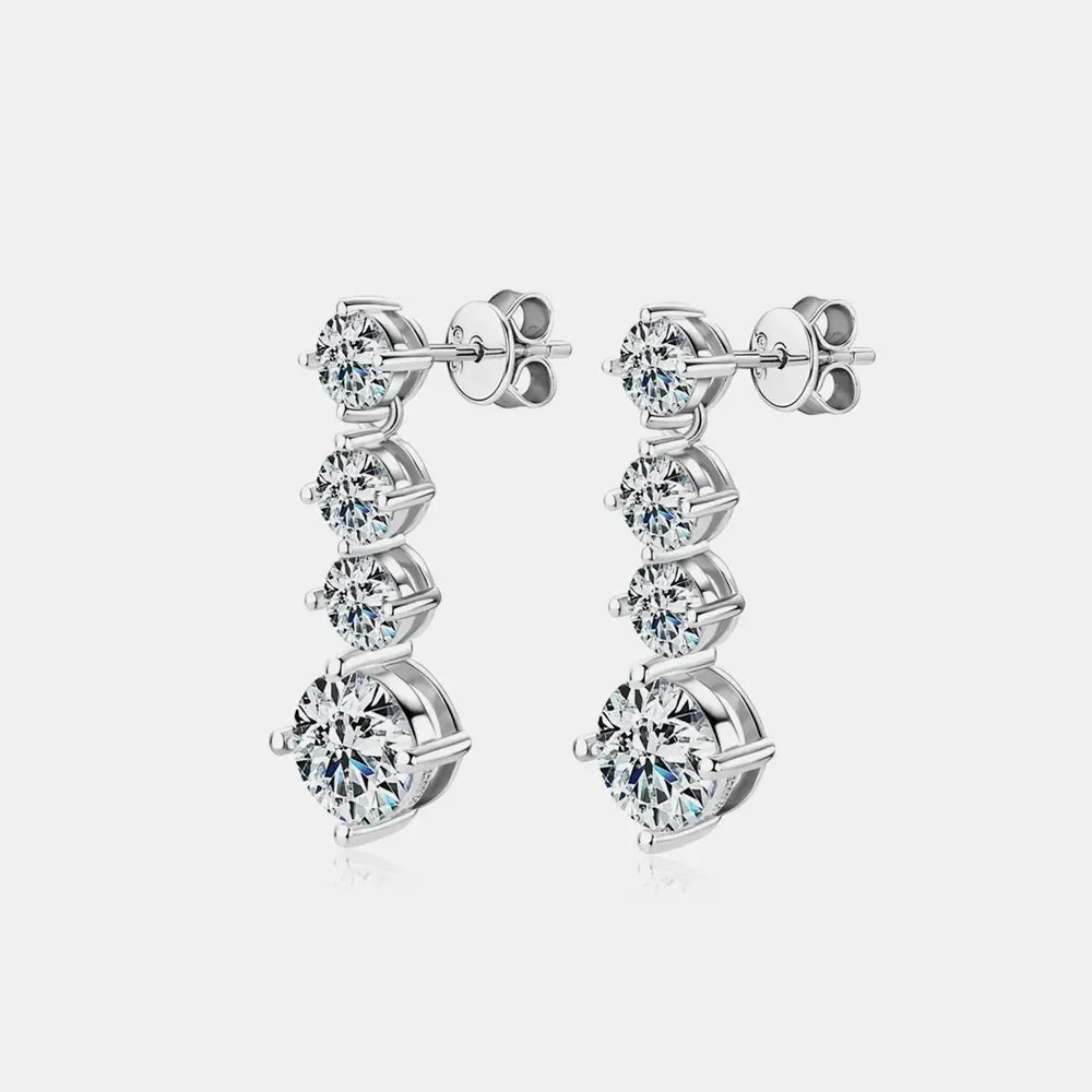 Elegant silver drop earrings with five round-cut clear stones on a white background
