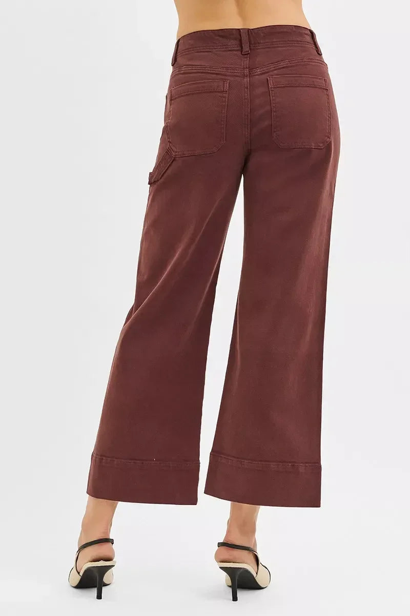 Back view of woman wearing high-waisted wide-leg brown pants and heels