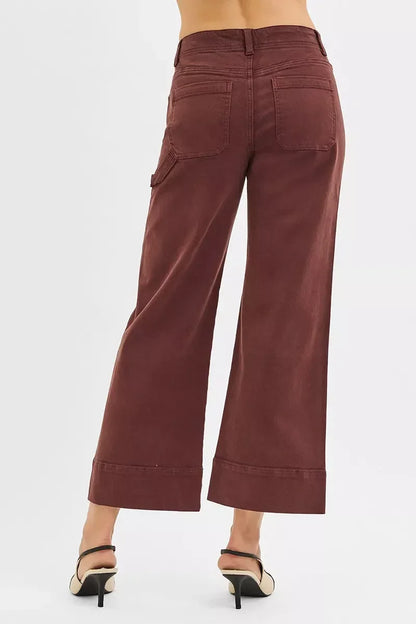 Back view of woman wearing high-waisted wide-leg brown pants and heels