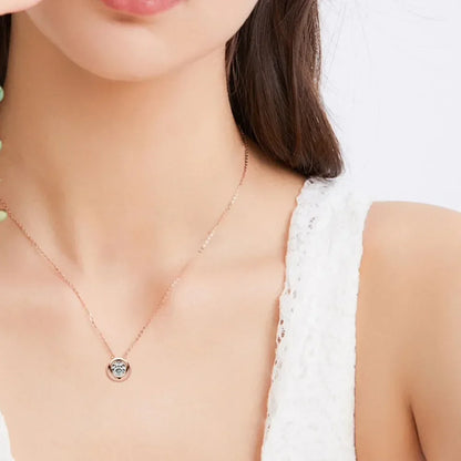 Woman wearing a delicate gold pendant necklace and white textured sleeveless top