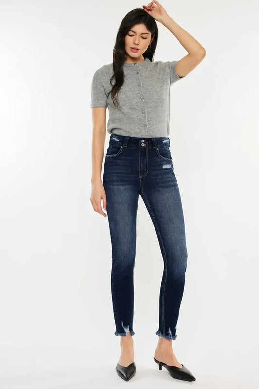 Woman wearing a short sleeve grey knit top and high waisted dark wash skinny jeans with frayed hems