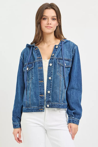 woman wearing a button-up Denim Jacket with Hoodie, white tank top and white jeans on a white background

