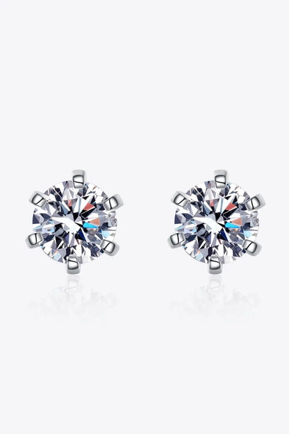 Pair of round cut crystal stud earrings with silver prong settings on white background
