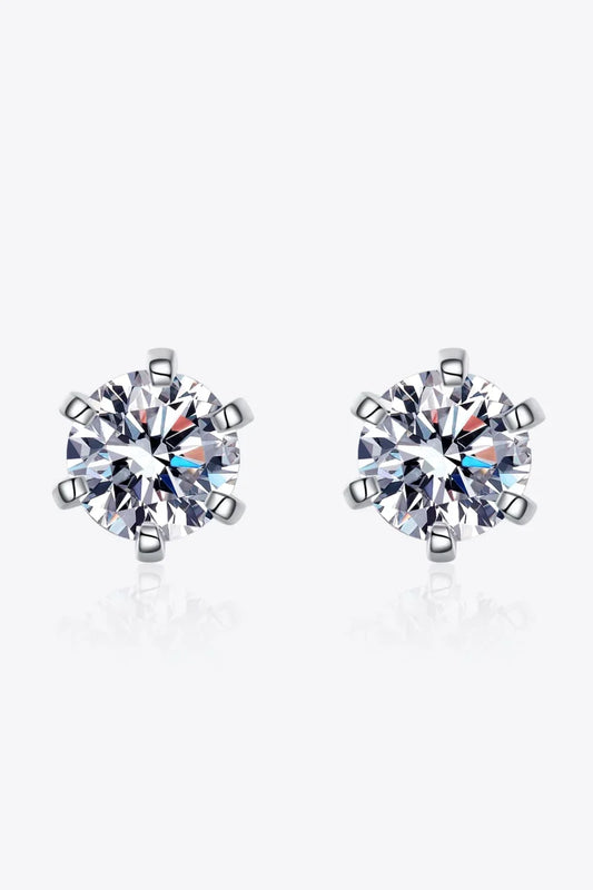 Pair of round cut crystal stud earrings with silver prong settings on white background