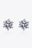 Pair of round cut crystal stud earrings with silver prong settings on white background