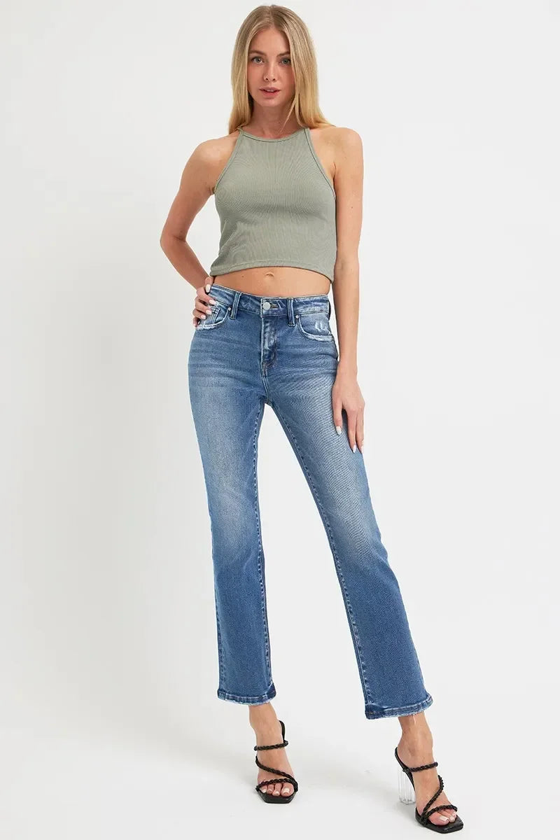 Woman wearing sage green ribbed crop top and high-waisted blue straight-leg jeans