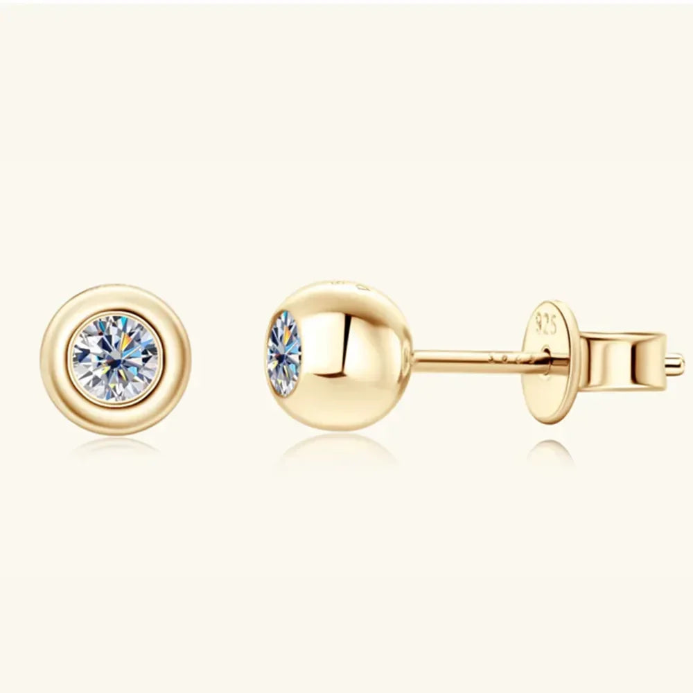 Gold stud earrings with round clear gemstones, minimalist and elegant design