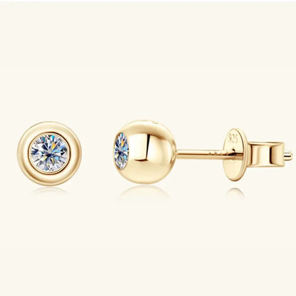 Gold stud earrings with round clear gemstones, minimalist and elegant design