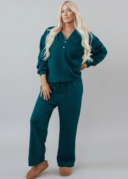Woman modeling teal textured matching loungewear set with relaxed fit and button top