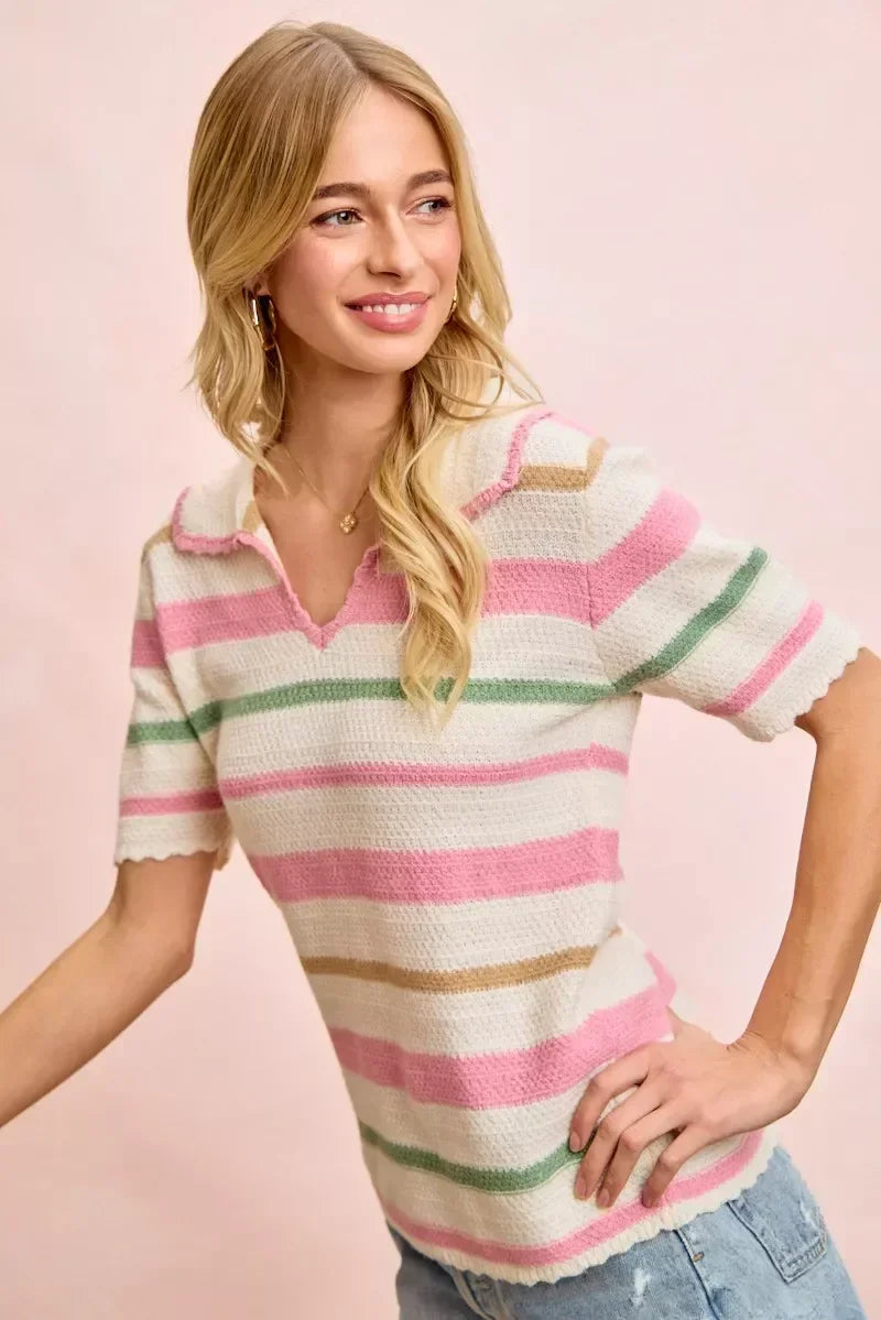 Woman wearing a short-sleeve pastel striped knit top with collar, paired with light blue jeans.